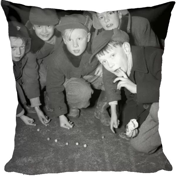 Boys playing marbles