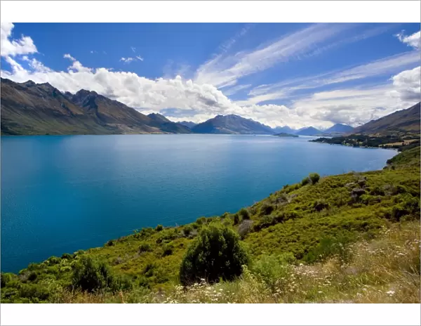 Lake Wakatipu surrounded by stunning mountains with dispersing clouds after a heavy thunderstorm Queenstown, Otago, South Island, New Zealand