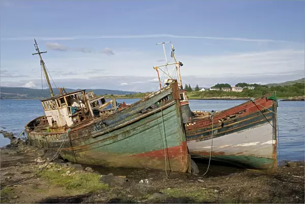 Old fishing boats rotting on beach, Isle of Mull, Scotland, UK