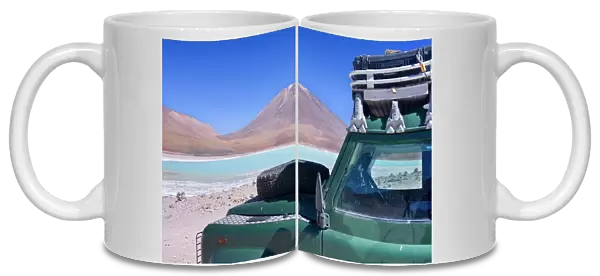Landrover at Laguna Verde - a Landrover Defender is parked at turqoise coloured Green Laguna and volcano Lincancabur on the stark Altiplano located at an altitude of about 4300 m above sea level - southwestern Bolivia - Province Potosi - Bolivia