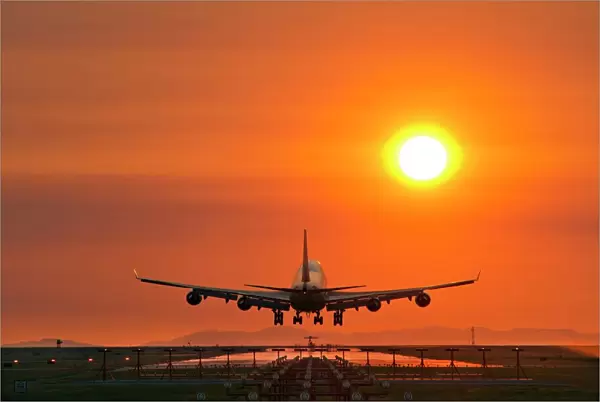 Aeroplane landing at sunset