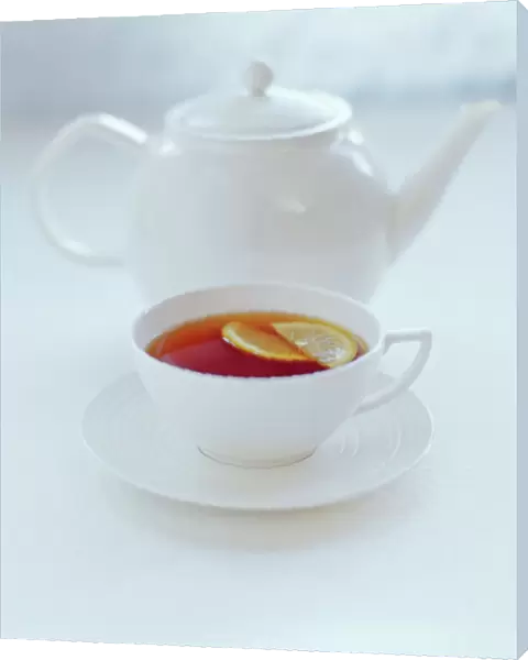 Tea. Pot and cup of tea with a slice of lemon