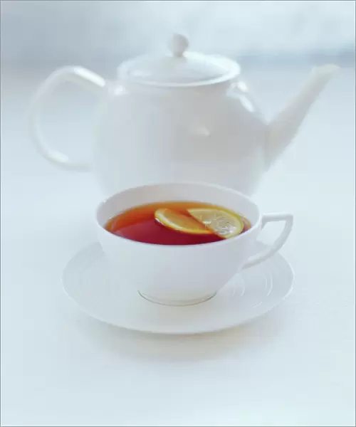 Tea. Pot and cup of tea with a slice of lemon