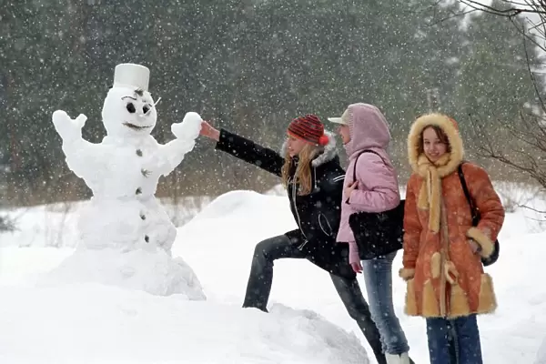 Teenage girls with a snowman