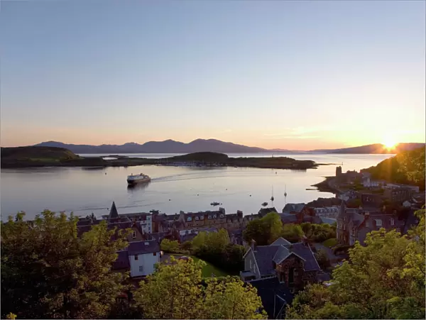 View over Oban Bay from McCaigs Tower, sunset, ferry coming into port, Oban, Argyll and Bute, Scotland, United Kingdom, Europe