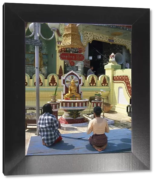 Two people praying at a pagoda, Yangon (Rangoon), Myanmar (Burma), Asia