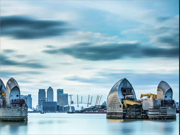Thames Barrier on River Thames and Canary Wharf in the background, London, England