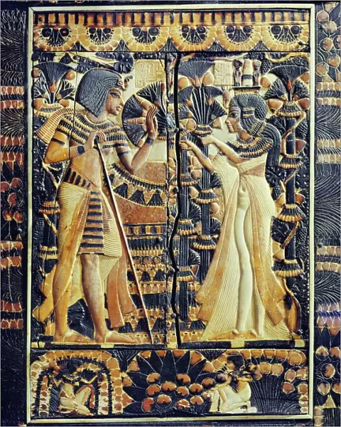 Painted ivory plaque from the lid of a coffer showing Tutankhamun and Ankhesenamun in a garden