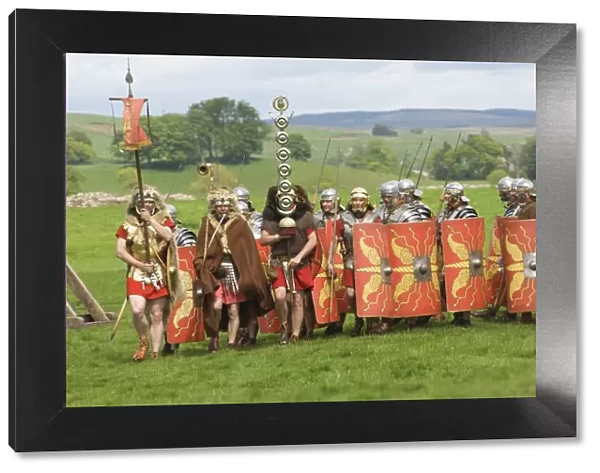Roman soldiers of the Ermine Street Guard, marching in column led by Standard Bearers