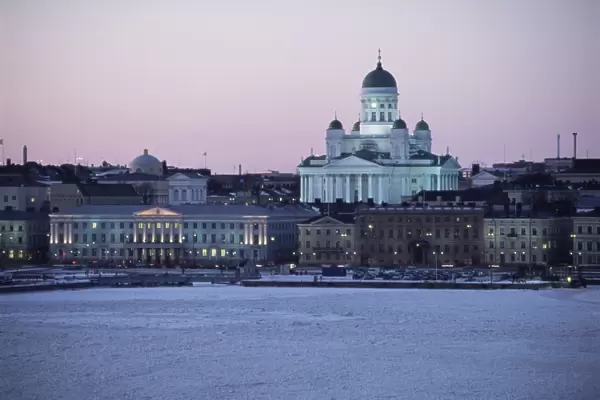 Dusk light on the Lutheran Christian cathedral in winter snow, across the frozen Baltic Sea