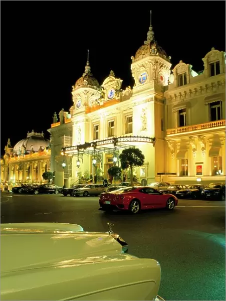 Rolls Royce and Ferrari parked in front of the Casino at night, Monte Carlo