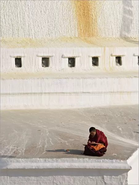 Tibetan Buddhist monk reading scriptures at the Boudha