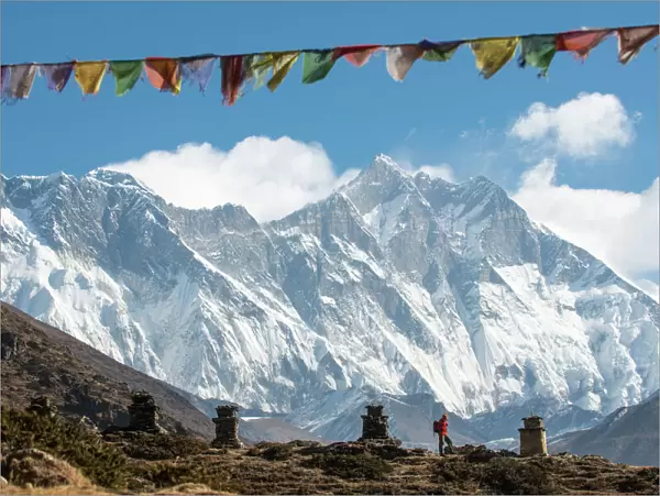 A trekker on their way to Everest Base Camp, Mount Everest is the peak to the left