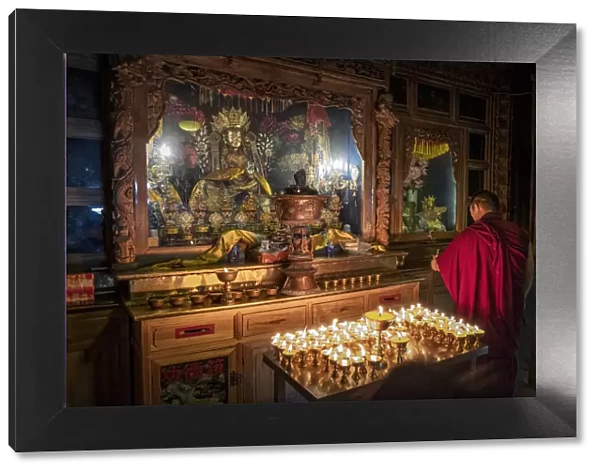 A Buddhist monk praying in the Bati temple, Gansu, China, Asia
