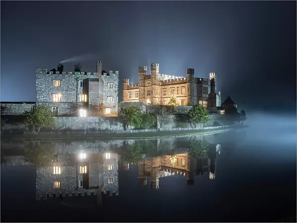 Leeds Castle illuminated in evening mist, winter, near Maidstone, Kent, England, United Kingdom, Europe