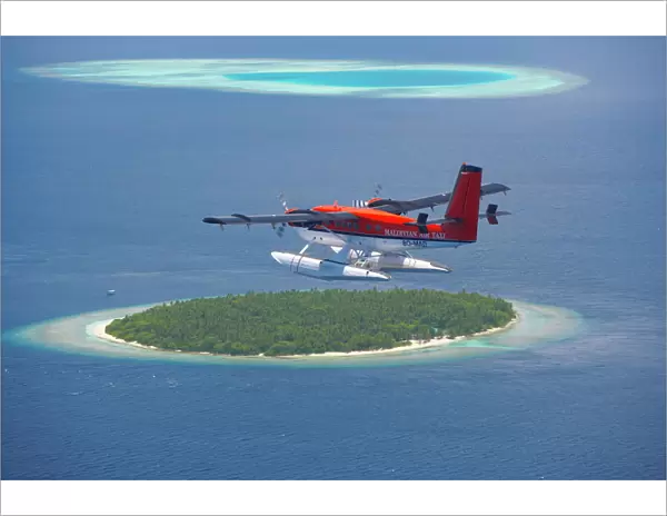 Maldivian Air Taxi flying above island, Maldives, Indian Ocean, Asia