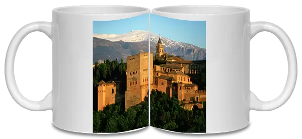 The Alhambra Palace, UNESCO World Heritage Site, with the snow covered Sierra Nevada mountains in the background, Granada, Andalucia