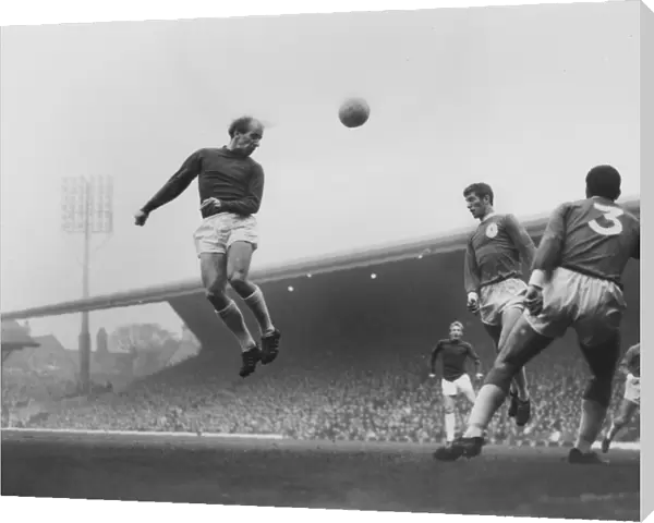 Bobby Charlton leaps to head the ball in the 1964  /  5 season