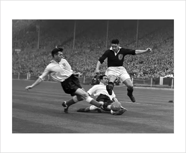 Englands Malcolm Barrass slides in to tackle Billy Liddell - 1952  /  3 British Home Championship