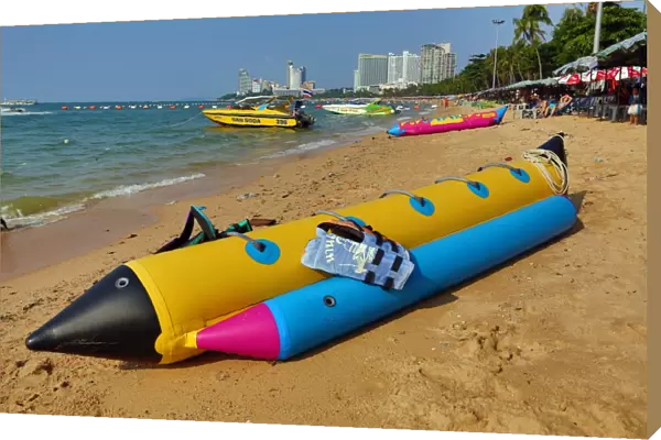 Beach scene with an inflatable banana boat on the seafront of Pattaya, Thailand