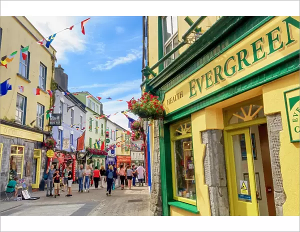 Europe, Dublin, Ireland, Tourists walking along Galway town streets and sitting