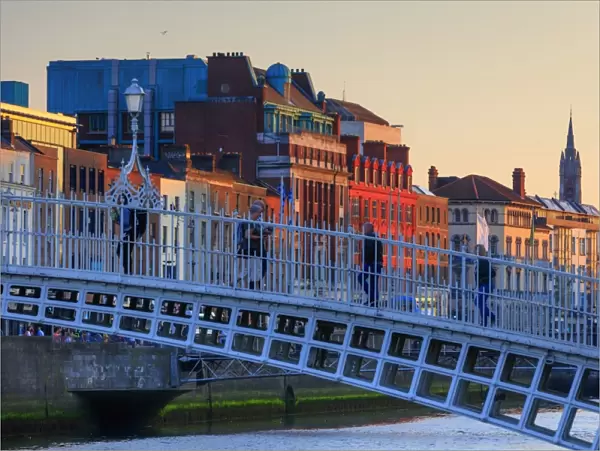 Europe; Dublin, Halfpenny bridge and Liffey river at sunset