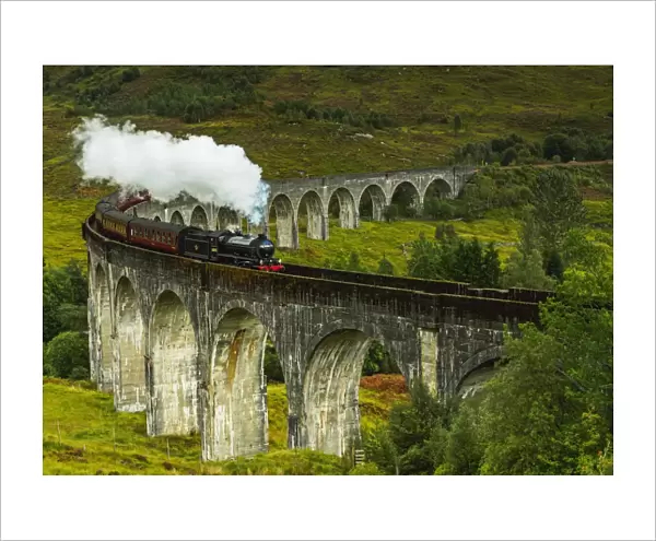UK, Scotland, Highlands, Jacobite Steam Train crossing the Glenfinnan Viaduct