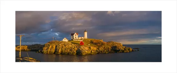USA, Maine, York Beach, Nubble Light Lighthouse with Christmas decorations, sunset