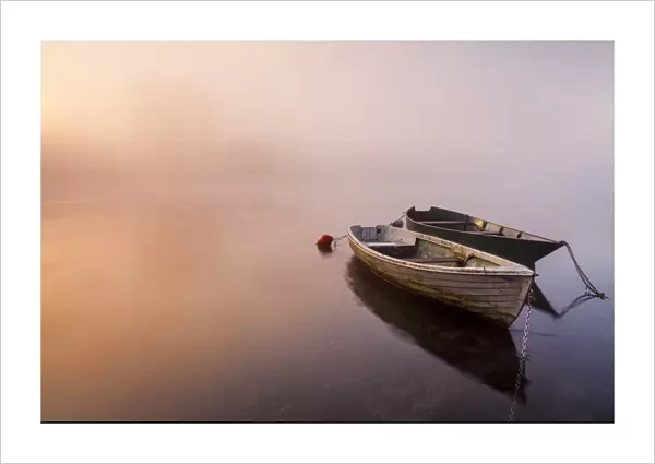 Brivio, Lombardy, Italy. Two boats on the Adda river at sunrise