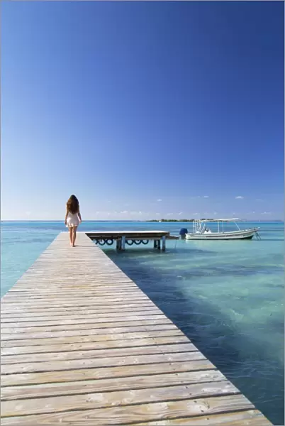Woman walking on jetty, Hauru Point, Mo orea, Society Islands, French Polynesia (MR)