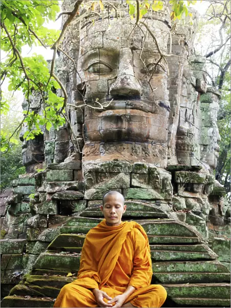 Southeast Asia, Cambodia, Siem Reap, Angkor temples, Buddhist monk in saffron robes meditating