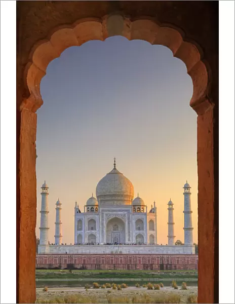 India, Taj Mahal at sunset framed by a temple arch
