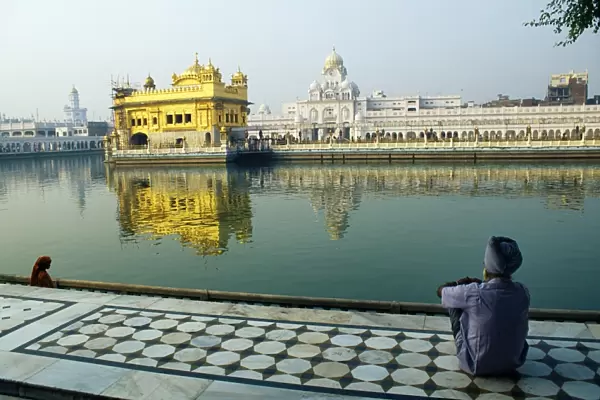 A Sikh pilgrim pauses for reflection by Amrit Sarovar