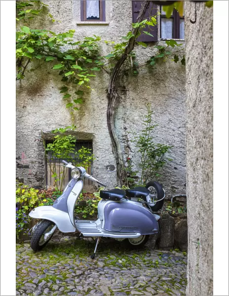 White and grey Lambretta Innocenti scooter in a courtyard, Morbegno, province of Sondrio