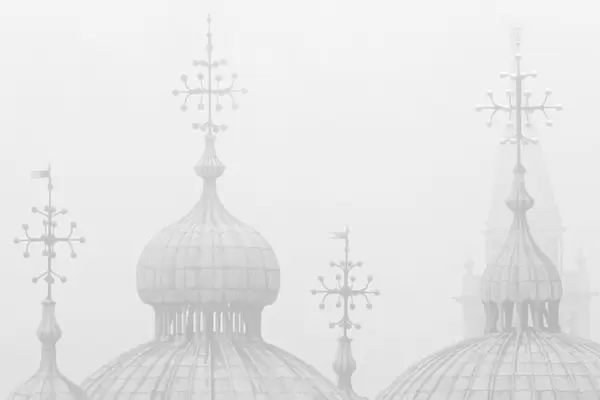 Silhouettes of St. Marks Cathedral and Campanile San Giorgio Maggiore in the fog
