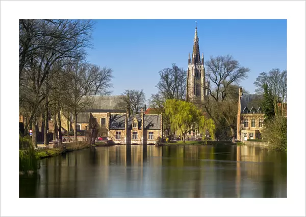 Picturesque view of the old town with belfry of Church of Our Lady in Bruges in the