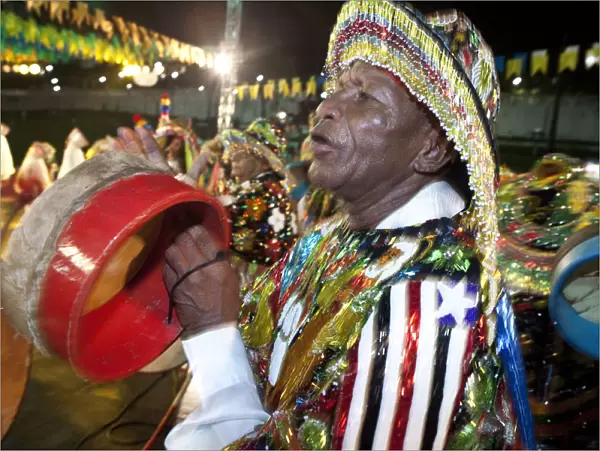 South America, Brazil, Maranhao, Sao Luis, a costumed dancer with tamborim drum instrument