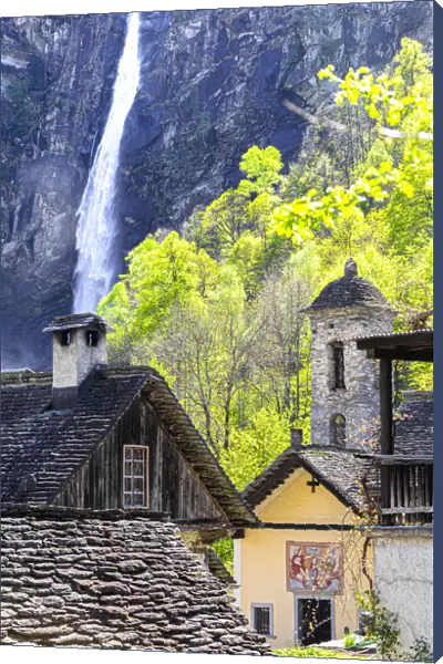Traditional houses and church of Foroglio with the waterfall in the background, Val