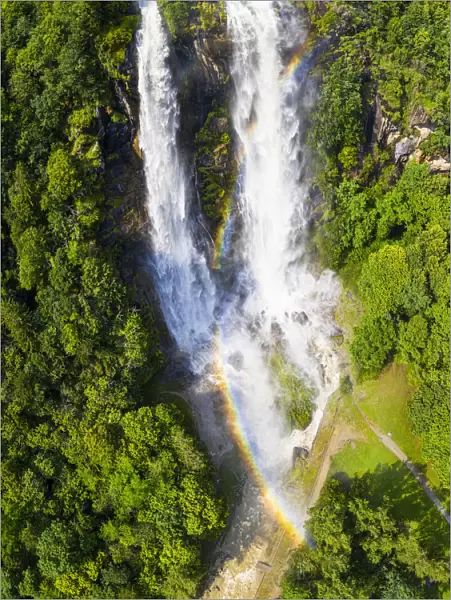 Aerial view of Acquafraggia Waterfall in spring with a rainbow. Valchiavenna, Valtellina