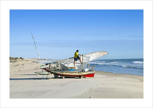 South America, Brazil, Ceara, Fortaleza, a fisherman tending his jangada on the beach