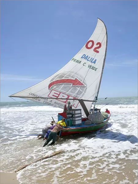 South America, Brazil, Ceara, Fortaleza, fishermen launching a jangada on the beach