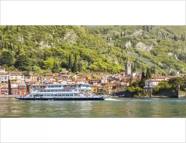 A touristic ferry crossing Lake Como with the village of Varenna in the background