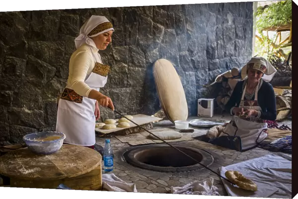 Traditional way of baking bread in the tandoor. Armenia