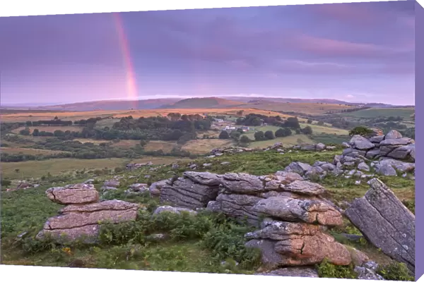 Rainbow over Dartmoor at dawn, Holwell Tor, Dartmoor, Devon, England. Summer (August)