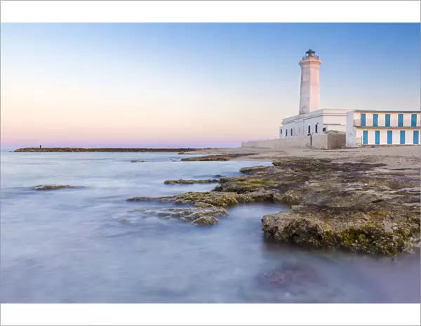 The lighthouse and beach of San Cataldo at sunset. Province of Lecce, Salento, Apulia