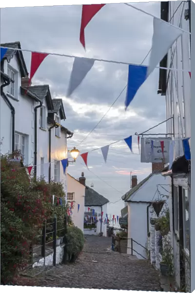 Bunting above the cobbled streets of Clovelly at dawn, North Devon, England. Summer