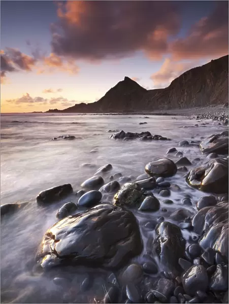 Sunset on the shoreline of Spekes Mill Mouth beach in North Devon, England