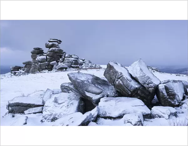 Snow covered granite rocks at Great Staple Tor, Dartmoor, Devon, England. Winter