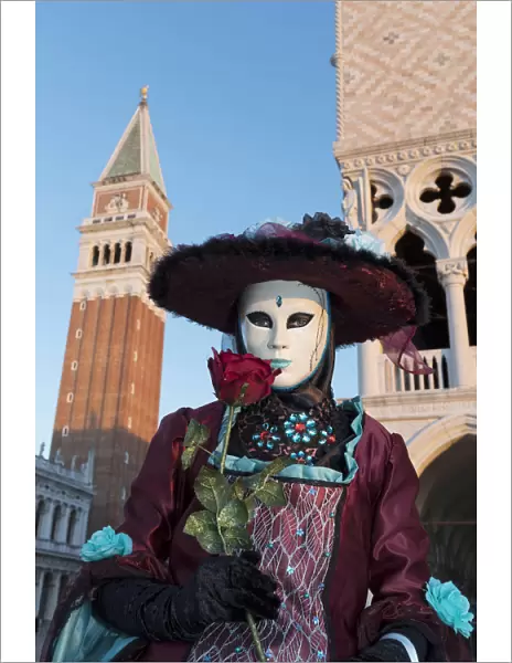 Woman in costume holding red rose during Carnival, Piazza San Marco (St