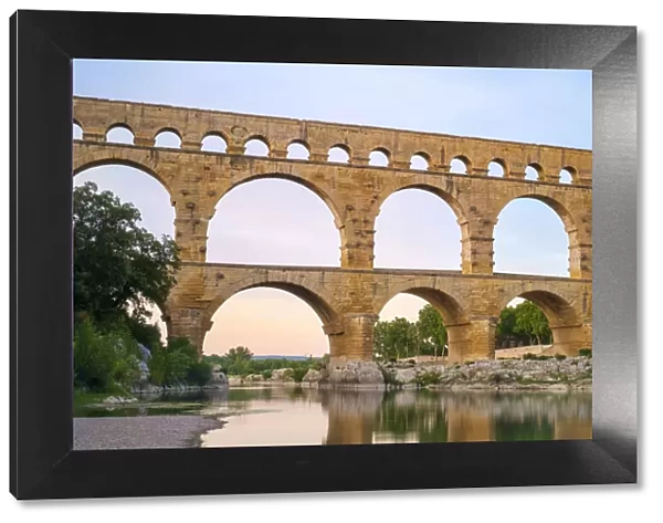 Pont du Gard Roman aqueduct over Gard River at sunset, Gard Department
